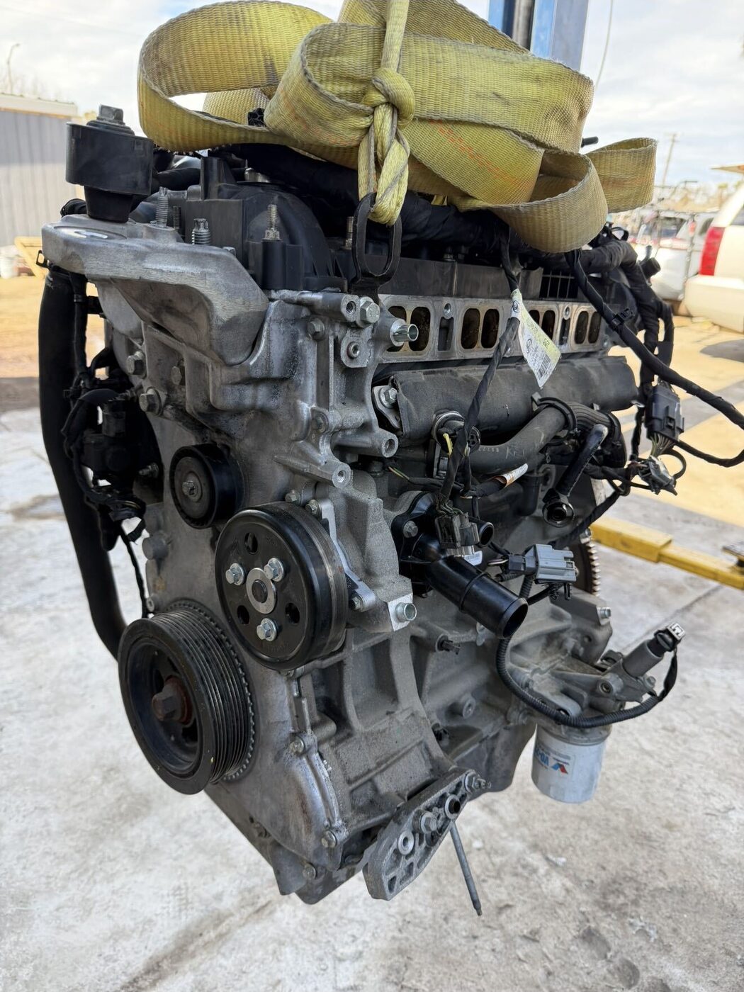 Engine strapped to a hoist ready for installation
