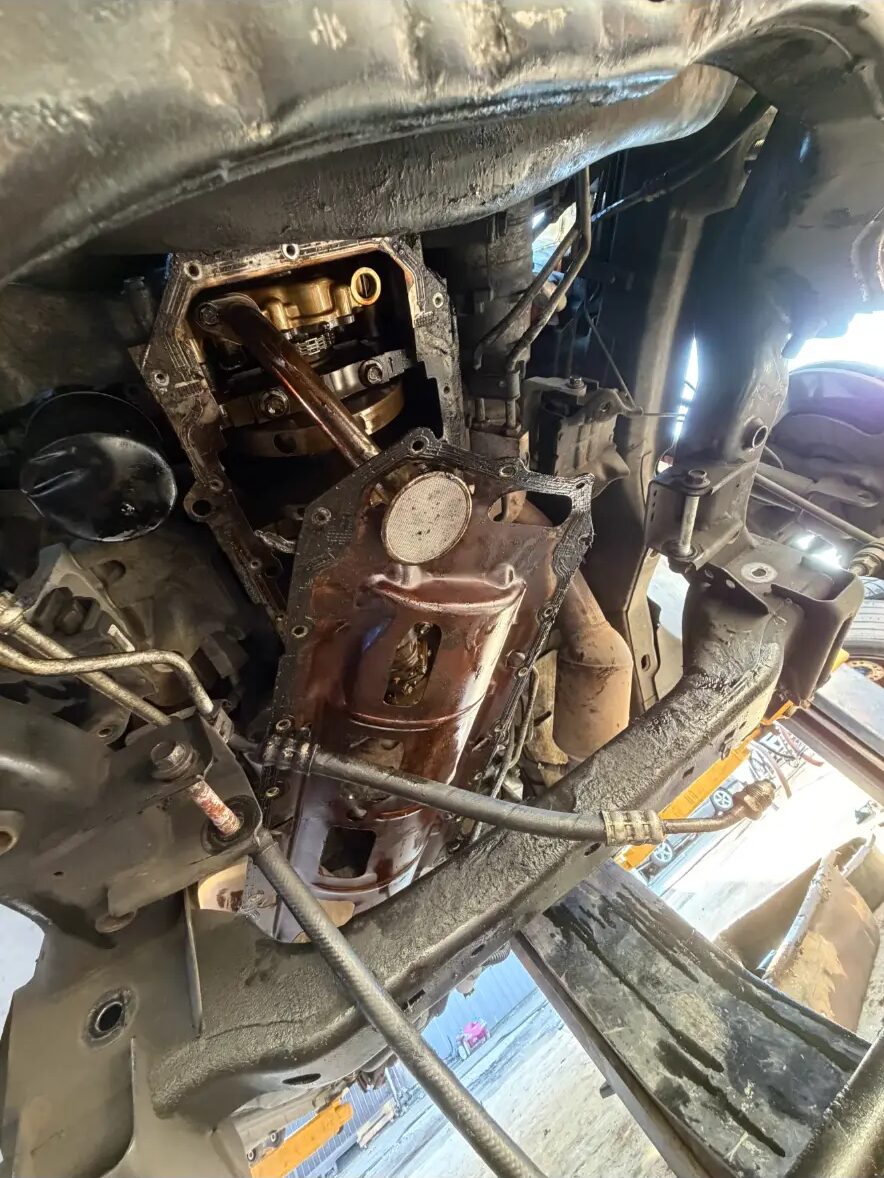 Oil pan and pickup removed during an engine repair