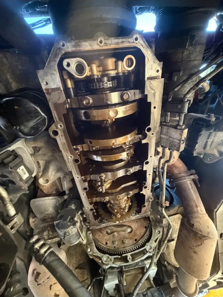 Oil pan removed showing crankshaft, bearings and flexplate